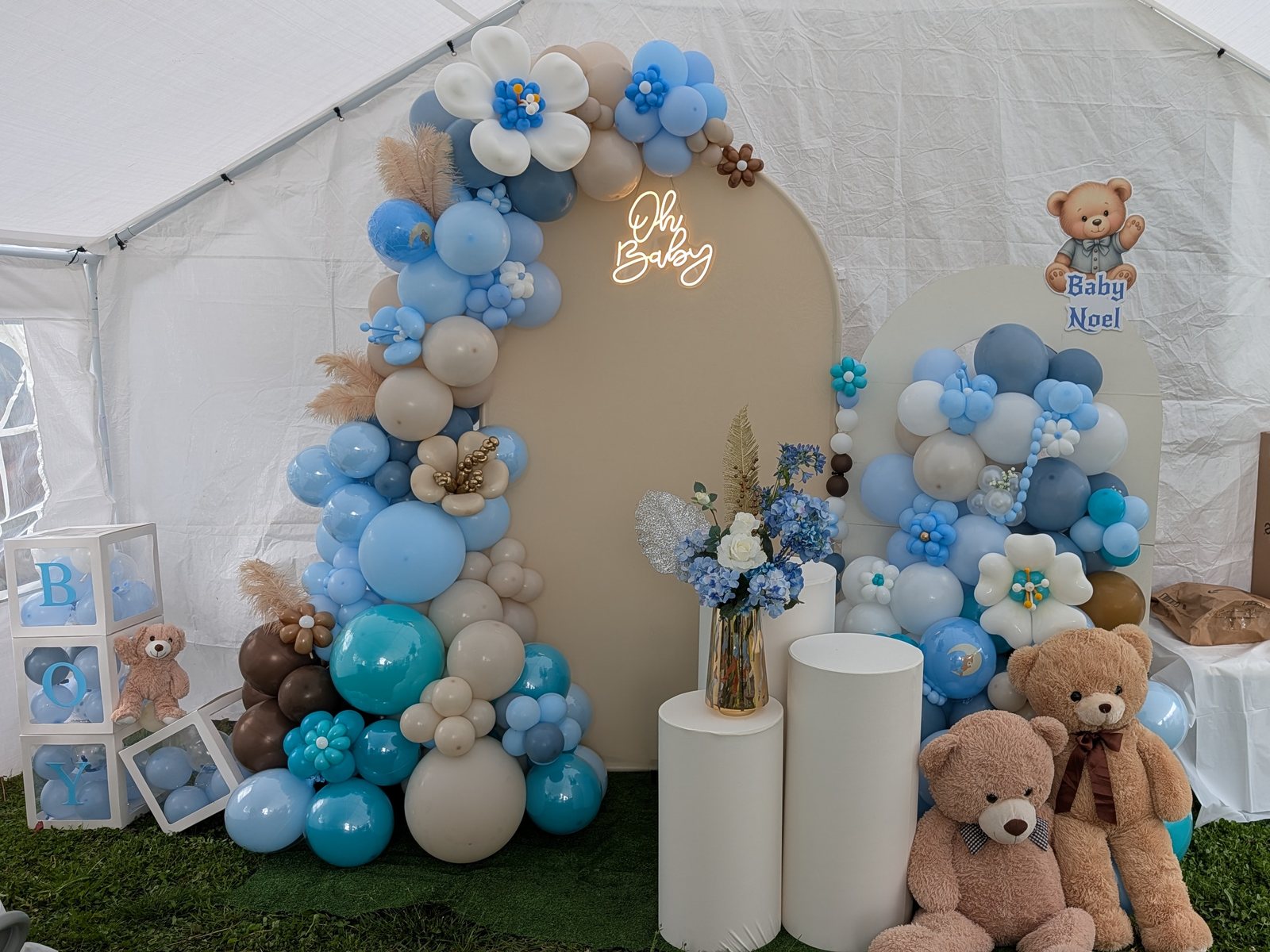 Powder blue baby shower balloon installation with florals, teddy bears, and custom backdrop